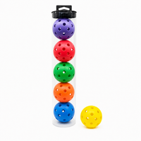 Clear tube of 6 multi-colour pickleball balls with a yellow ball beside it