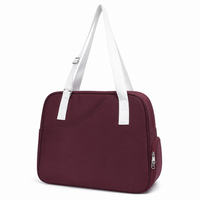 Red wine pickleball tote bag with a white strap, angled front paddle pocket and side zip pocket
