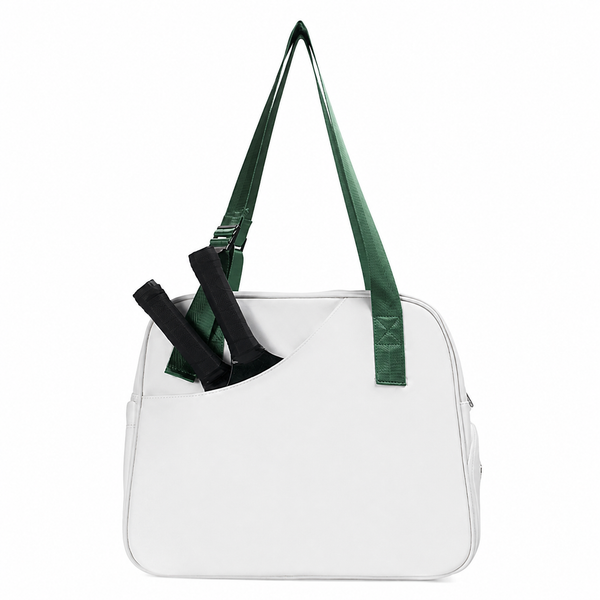 White pickleball tote bag with a green strap and two paddles in the angled front pocket