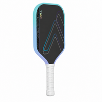 Light blue T700 carbon fibre pickleball paddle at an angle, showing the cyan-to-lavender edge guard and white grip