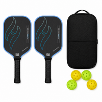 T700 Pro pickleball paddle set in gradient blue — two carbon paddles with flame graphic, a black zip carry case and four indoor and outdoor balls