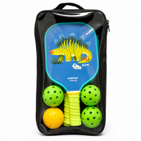Kids pickleball set in a clear carry bag with a blue dinosaur paddle and four balls