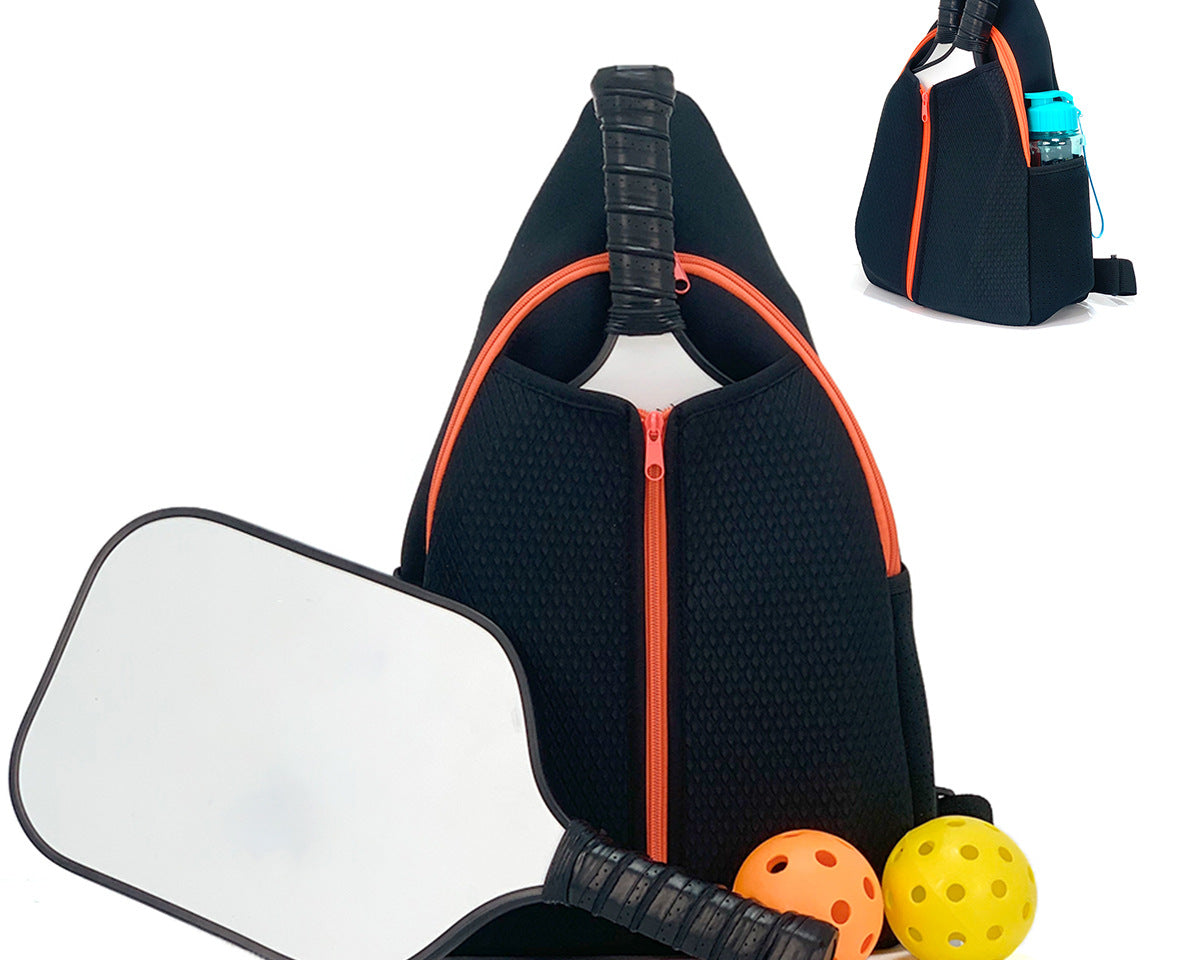 Black neoprene pickleball sling bag with honeycomb texture front panel, front orange zipper pocket and adjustable crossbody strap