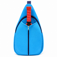 Front view blue neoprene pickleball sling bag crossbody with paddle inserted in open-top compartment
