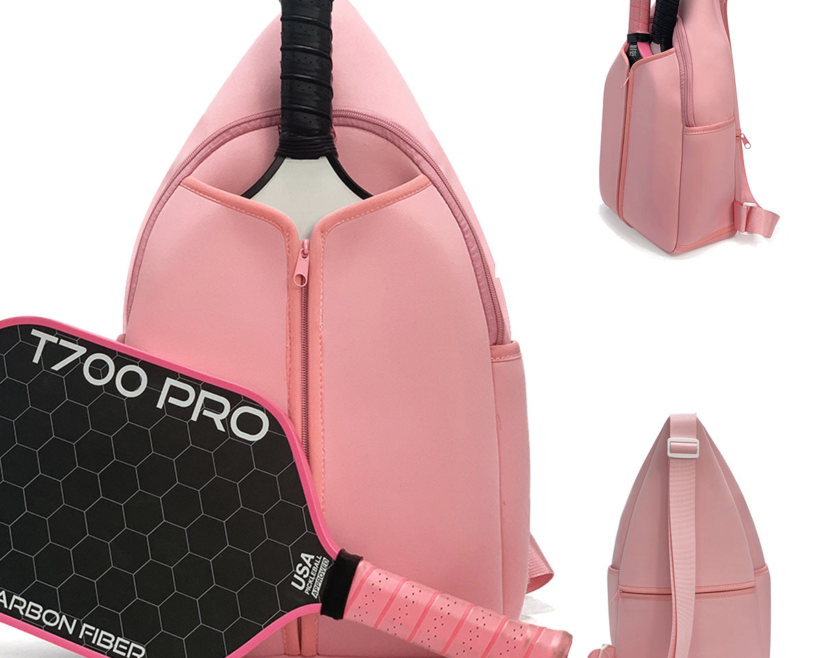 Close-up of pink neoprene pickleball sling bag with honeycomb texture, front zipper pocket and adjustable crossbody strap