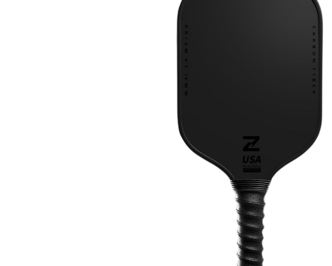 Prism V7 all-black carbon fiber pickleball paddle with T700 matte friction surface, black TPU edge guard and ribbed grip handle
