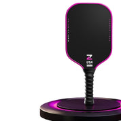 Prism V7 carbon fiber pickleball paddle in pink with T700 matte friction surface, premium TPU edge guard and anti-slip black ribbed handle