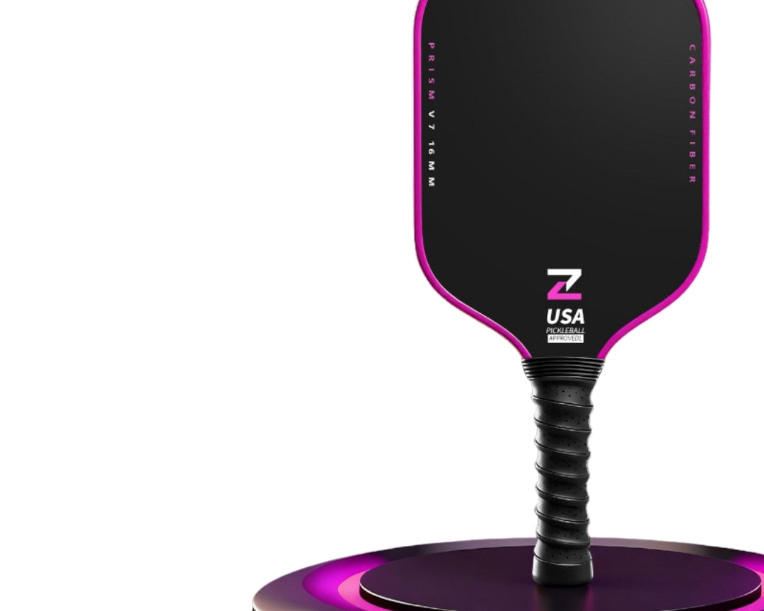 Prism V7 carbon fiber pickleball paddle in pink with T700 matte friction surface, premium TPU edge guard and anti-slip black ribbed handle