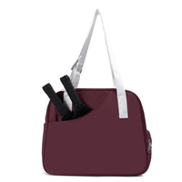 Pickleball tote bag with a front paddle pocket, shown with pickleball paddles and gear