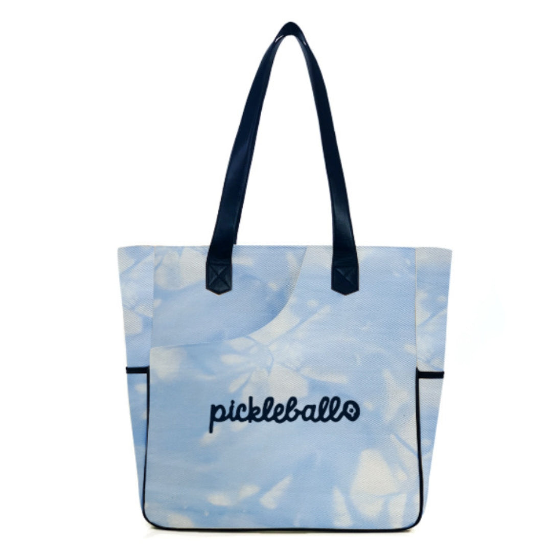 Flat lay of women's pickleball bag showing quilted paddle protection, zipper compartments, and neoprene detailing