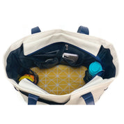 Interior view of women's pickleball bag showing paddle storage, phone pocket, and accessory organizer pockets