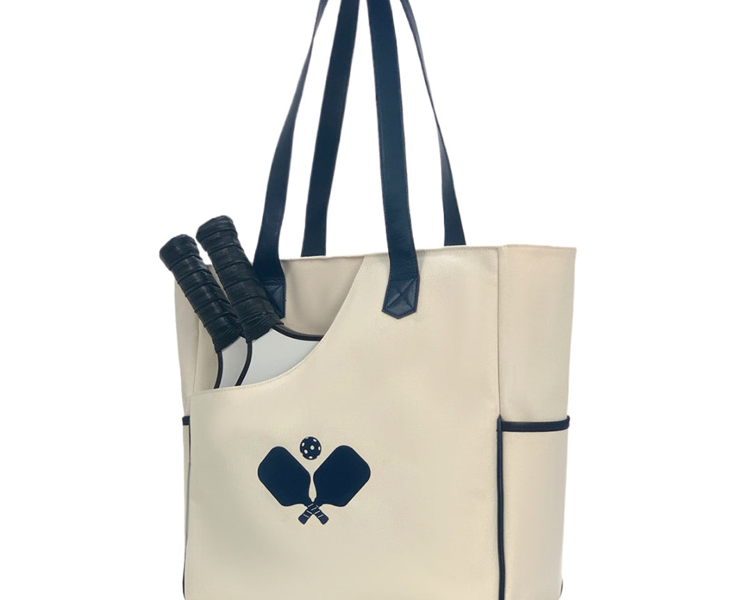 Women's pickleball bag in white racket pattern, convertible tote and backpack design with quilted paddle protection